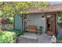 Inviting front entrance with a wooden bench, flowers, and a view into the home at 3582 Smuggler Way, Boulder, CO 80305
