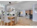 Open living space with hardwood floors, modern lighting, and a cozy fireplace at 3582 Smuggler Way, Boulder, CO 80305