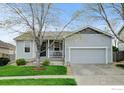 Charming light-gray home with a well-manicured lawn and attached two-car garage at 4312 Windmill Dr, Brighton, CO 80601