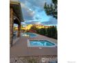 Community pool and hot tub area with stone detailing and a relaxing atmosphere at 457 Black Feather Loop # 704, Castle Rock, CO 80104