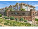 Black Feather apartment complex entrance sign with stone and lush landscaping at 457 Black Feather Loop # 704, Castle Rock, CO 80104