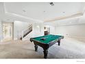 Finished basement offers a pool table, space for entertaining, and a bathroom at 4648 Belford Cir, Broomfield, CO 80023