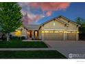 Charming home boasts a three-car garage, well-manicured lawn, and stone accents at 4648 Belford Cir, Broomfield, CO 80023
