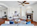 Bright, open living room with fireplace and hardwood floors at 4648 Belford Cir, Broomfield, CO 80023