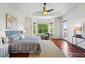 Spacious main bedroom boasts a bay window, ceiling fan, and hardwood floors at 4648 Belford Cir, Broomfield, CO 80023