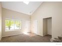 Bright living room features vaulted ceiling and a large window at 4860 W 125Th Ave, Broomfield, CO 80020