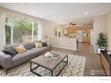 Bright living room features a comfortable sofa, neutral decor, and a large window for natural light at 4860 W 125Th Ave, Broomfield, CO 80020
