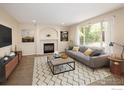Comfortable living room featuring a fireplace, plush sofa, and ample natural light at 4860 W 125Th Ave, Broomfield, CO 80020