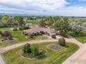 Ranch style home with beautiful flowerbeds and mature trees at 5557 Aspen Ave, Erie, CO 80516
