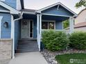 Inviting front porch with well-maintained landscaping, offering a warm welcome to the home at 6124 Taylor St, Frederick, CO 80530