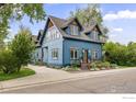 Stylish two-story home boasts blue siding, bright windows, and landscaped yard at 700 Johnson St, Louisville, CO 80027