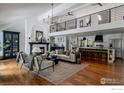 Spacious living room with high ceilings, fireplace, hardwood floors and open layout to the kitchen at 7204 Rustic Trl, Boulder, CO 80301