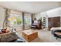 Spacious living room with a piano, large windows, and stylish decor at 860 Quintana Ln, Erie, CO 80516