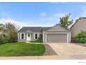 Charming single-Gathering home with a well-maintained lawn, mature trees and a two-car garage at 904 Clover Cir, Lafayette, CO 80026