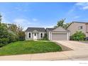 Charming single-Gathering home with a well-maintained lawn, mature trees and a two-car garage at 904 Clover Cir, Lafayette, CO 80026