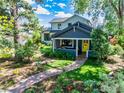 Inviting two-story home with a cozy front porch and well-manicured lawn at 908 Rex St, Louisville, CO 80027