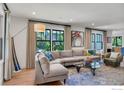 Bright living room with hardwood floors, large windows, and comfortable seating at 908 Rex St, Louisville, CO 80027