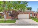 Lovely single-story brick home with a large two-car garage and mature landscaping at 1012 Boxelder Cir, Longmont, CO 80503