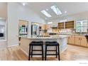 Bright kitchen with skylights, granite counters, a center island, and stainless appliances at 1012 Boxelder Cir, Longmont, CO 80503