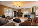 Cozy living room featuring wood floors and a comfortable seating arrangement at 110 Lucerne Dr, Lafayette, CO 80026