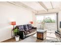 Comfortable living room with natural light streaming in from the balcony doors, perfect for relaxation at 1441 N Humboldt St # 302, Denver, CO 80218