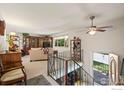 Open living room featuring a ceiling fan and multiple windows for natural light at 1560 Findlay Way, Boulder, CO 80305