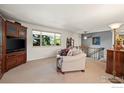 Cozy living room with plush seating, built in storage, and a scenic window view at 1560 Findlay Way, Boulder, CO 80305