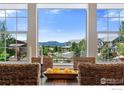 Inviting dining room featuring a large window with breathtaking mountain views and a wood dining table at 16069 Pikes Peak Dr, Broomfield, CO 80023