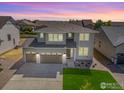 Aerial view of a modern home with a three-car garage situated in a residential neighborhood at 16860 Mckay Dr, Mead, CO 80542