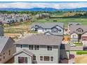 A high altitude aerial view looking over the roofs of houses within the community at 16860 Mckay Dr, Mead, CO 80542