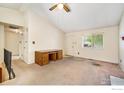 Bright living room featuring neutral walls, carpet, ceiling fan, desk, and great natural lighting at 2167 Hackberry Cir, Longmont, CO 80501