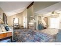 Inviting living room boasts stylish decor, vaulted ceilings and abundant natural light at 2229 S Elkhart St, Aurora, CO 80014