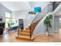 Bright foyer features hardwood floors, a grand staircase, and large windows filling the space with natural light at 2345 Spotswood Pl, Boulder, CO 80304