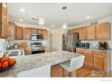 This kitchen features granite countertops, stainless steel appliances and plenty of counter seating at 24285 E Wagontrail Ave, Aurora, CO 80016