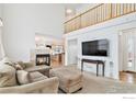 Open concept living room with fireplace and vaulted ceilings at 24285 E Wagontrail Ave, Aurora, CO 80016