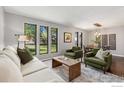 Comfortable living room featuring ample natural light, hardwood floors, and stylish decor at 2537 Lanyon Dr, Longmont, CO 80503