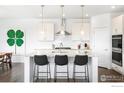Modern kitchen with stainless steel appliances, granite countertops, and stylish pendant lighting at 2905 S Flat Cir, Longmont, CO 80503