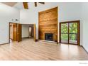 Open living room features a vaulted ceiling, wood fireplace, and sliding glass doors to the deck at 2962 Shadow Creek Dr # 306, Boulder, CO 80303