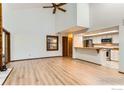 Bright living area with sleek hardwood floors, an open layout, and a breakfast bar with kitchen view at 2962 Shadow Creek Dr # 306, Boulder, CO 80303