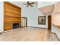 Sun-filled living room with high vaulted ceilings, wood fireplace, and light hardwood floors at 2962 Shadow Creek Dr # 306, Boulder, CO 80303
