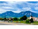 Scenic view of the mountains from the front of this property on a partly cloudy day at 3116 47Th St, Boulder, CO 80301