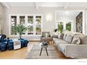 Bright living room boasting stylish furnishings, hardwood floors, and a view to lush outdoor scenery at 32399 Woodland Dr, Evergreen, CO 80439