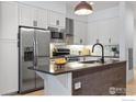Stylish kitchen featuring stainless steel appliances and a center island with breakfast bar at 3301 Arapahoe Ave # 106, Boulder, CO 80303