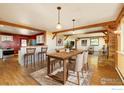 Bright dining room features hardwood floors, exposed beams, and a seamless connection to the open kitchen at 33090 Janelle Cir, Golden, CO 80403