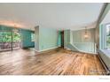 Sunlit living room features hardwood floors, open layout, and sliding glass doors at 4350 Butler Cir, Boulder, CO 80305
