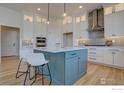 Spacious kitchen island with seating and pendant lighting and stainless appliances at 470 Muirfield Cir, Louisville, CO 80027