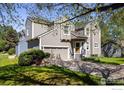 Charming two-story home featuring a two-car garage, a well-manicured lawn and inviting curb appeal at 5523 Stonewall Pl, Boulder, CO 80303