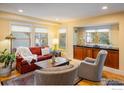 Comfortable living room with large windows, hardwood floors, plush seating, and stylish decor at 5523 Stonewall Pl, Boulder, CO 80303