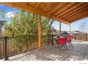 Relaxing back deck featuring a wood ceiling with views of the neighborhood at 6483 S Irvington Way, Aurora, CO 80016