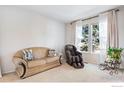 Cozy living room with comfortable seating and great natural light at 6483 S Irvington Way, Aurora, CO 80016